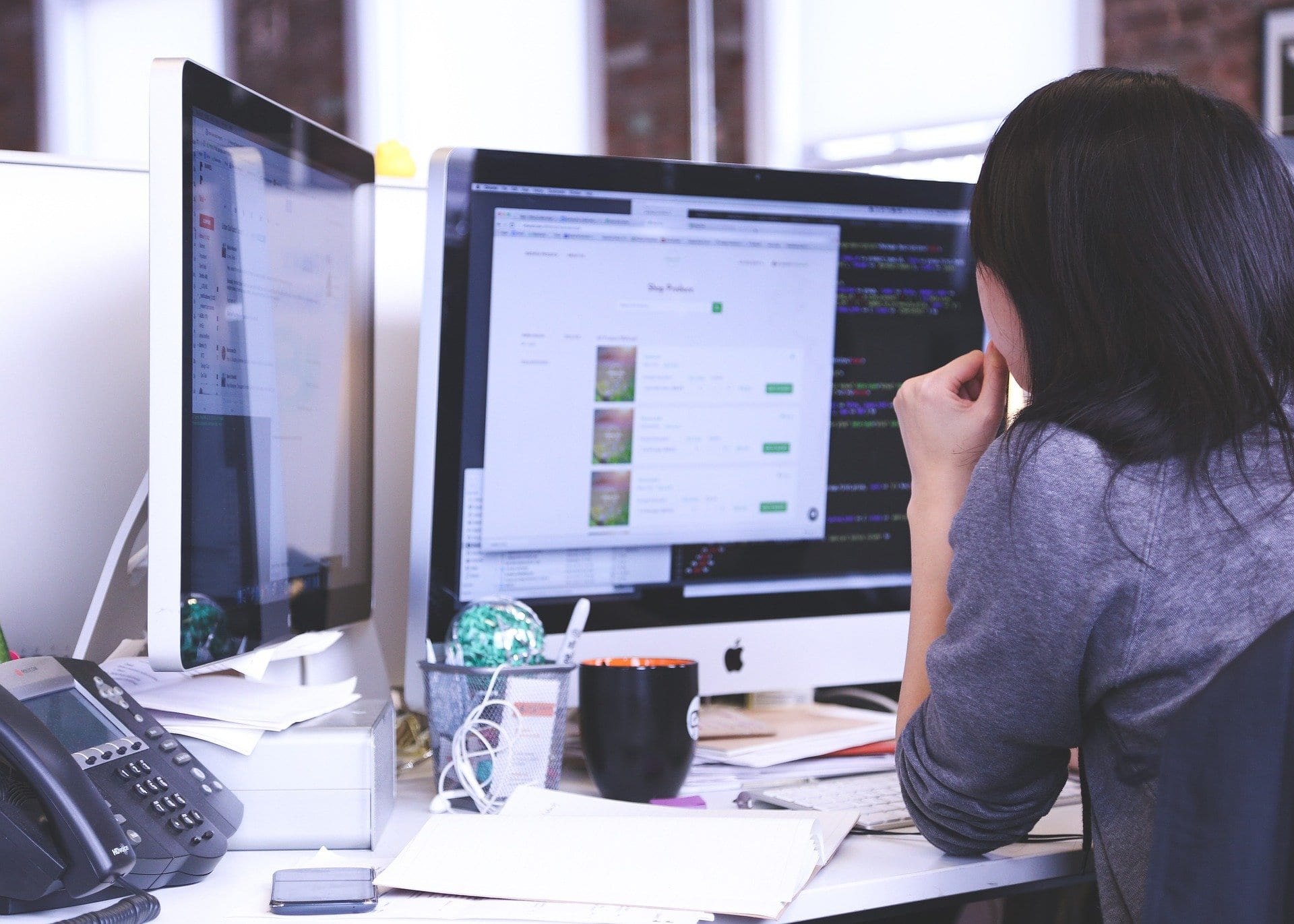 Employee working with dual monitors